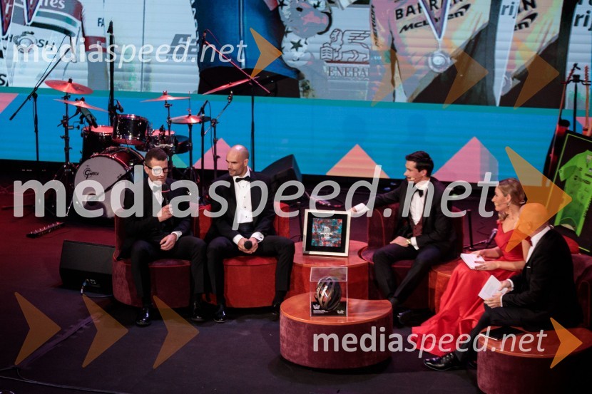  ... ;  Luka Mezgec, kolesar;  Primož Roglič, kolesar;  ... ;  ... Primož Roglič predal naziv botra, dobrodelna prireditev Olimpijskega komiteja Slovenije